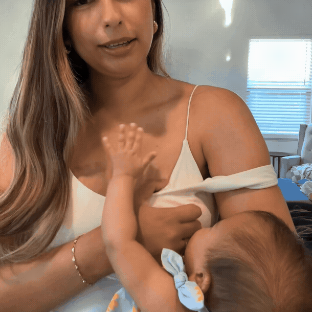 Baby latches through the hidden opening